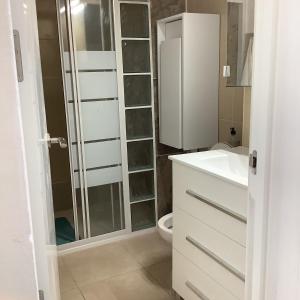 a bathroom with a shower and a sink and a toilet at Piscina directa in Playa Fañabe