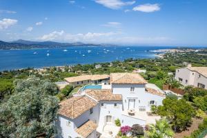 an aerial view of a house and the water at Les Agathea in Saint-Tropez
