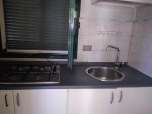 a kitchen with a sink and a stove at Camping village Internazionale in Metaponto
