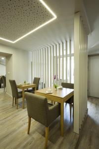 a dining room with two tables and chairs at Rua Grande Hotel in Viana do Castelo