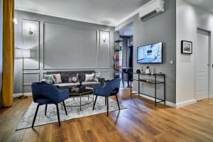 a living room with a couch and a table and chairs at LILIENBLUM CHIC Apartment ChicLife - Borgo Santa Caterina in Bergamo