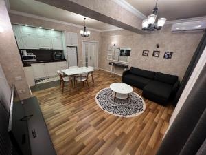a living room with a couch and a table at Park Azure 0568 in Baku +14 photos