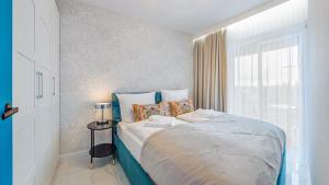 Ένα ή περισσότερα κρεβάτια σε δωμάτιο στο Apartament 308 Miami - Perłowa Przystań - Holiday City