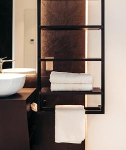 a bathroom with a towel rack with a sink at Villa Weingarten in Caldaro