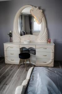 a bedroom with a white dresser and a mirror at Timeout Royal in Ellar