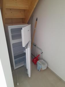 a small refrigerator in a room with a broom at V Pražské in Hodkovice nad Mohelkou