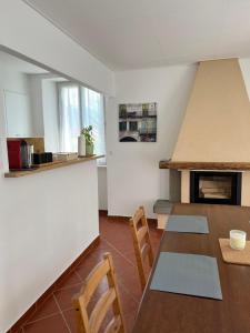 a kitchen and dining room with a table and chairs at Casa Romana in Gambarogno