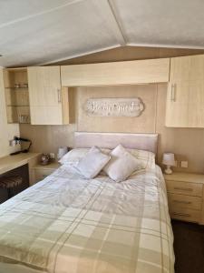 a bedroom with a large bed with two pillows at Modern 6 Berth Static Caravan, Hunstanton in Hunstanton +44 photos