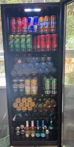 a refrigerator filled with lots of soda and drinks at Airport Szálló in Tököl