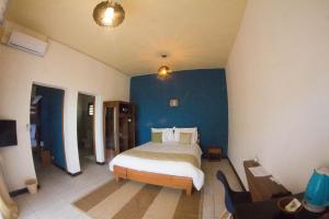 Säng eller sängar i ett rum på Ankoba Beach Hôtel