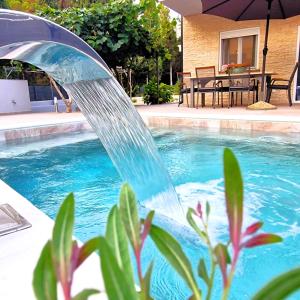 a water fountain in front of a swimming pool at Villa Brajkovic-near the sea and Rovinj center in Rovinj