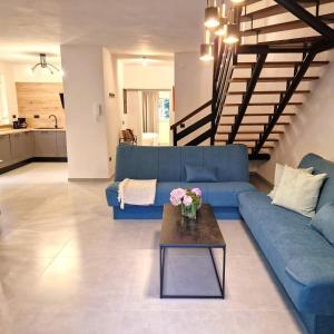 a living room with a blue couch and a table at Villa Brajkovic-near the sea and Rovinj center in Rovinj