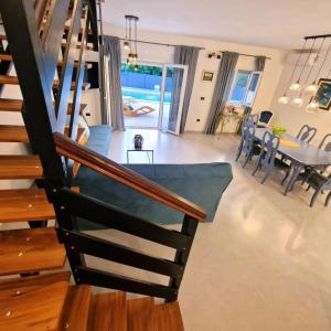 a living room with a staircase and a dining room at Villa Brajkovic-near the sea and Rovinj center in Rovinj