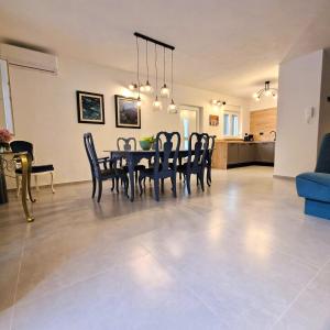 a dining room and living room with a table and chairs at Villa Brajkovic-near the sea and Rovinj center in Rovinj +17 photos