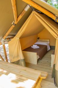 a tent with a bed inside of it at Luxor Chianti Glamping village in Castellina in Chianti
