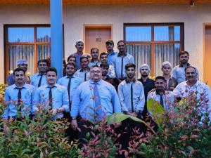 a group of men standing in front of a building at HOTEL NATURE AGRO RESORT in Sangamner
