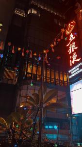a building with a sign in front of it at night at Sleep Cubee Hostel in Hong Kong