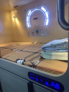 a bed in a room with a sign on it at Sleep Cubee Hostel in Hong Kong