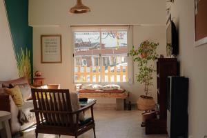 a living room with a window with a view of a building at Chepatagonia Hostel & Coworking in Puerto Madryn