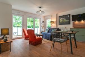 a living room with a couch and a table at Îlots Dido - Appt proche de la mer in Concarneau