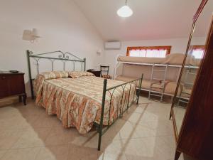 a bedroom with a bed and two bunk beds at Il sasso bed & breakfast in Sasso di Castalda