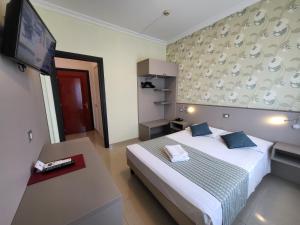 Voodi või voodid majutusasutuse Hotel Dei Fiori toas