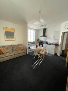 a living room with a couch and a table at 2 bedroom apartment in Kidderminster (The place to be) in Kidderminster