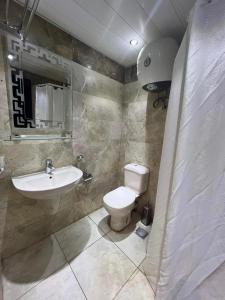 a bathroom with a toilet and a sink at شاليه بورتو مارينا على البحر in El Alamein