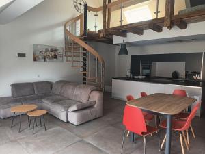 a living room with a couch and a table at Appartement in Otterswiller