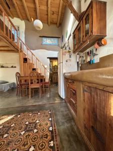 a kitchen with a table and a white refrigerator at Casa corazon in San Marcos Sierras +14 photos
