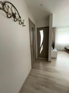 uma sala com um corredor com uma porta e um quarto em KOLIBRI em Ludza