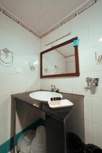a bathroom with a sink and a mirror at Yangthang Dzimkha Resort in Pelling
