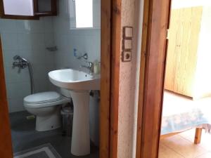 a bathroom with a sink and a toilet at 2bedrooms Cottage 1 in Palaiochóra