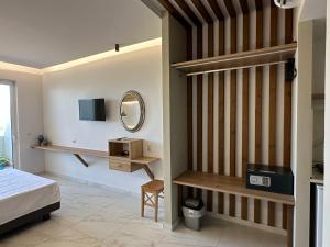 a bedroom with a bed and a mirror at Faliraki Star in Faliraki