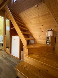 a wooden staircase in a tiny house at Brvnara Beli Kamen 1 in Bešenovački Prnjavor