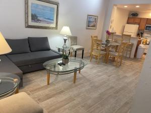 a living room with a couch and a table at Venetian Bay Villages Resort in Kissimmee