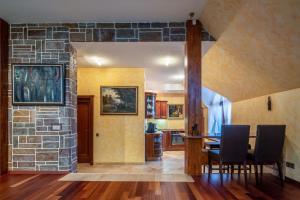 a kitchen and dining room with a stone wall at Amber dream Karkle in Karklė