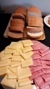 a bunch of different types of cheeses on a table at Hostería Las Semillas in Villa La Angostura