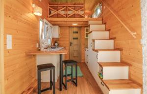 a small kitchen with stools in a tiny house at Lovely Home In Mayrhof With Wifi 