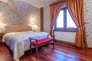 a bedroom with a bed with a red chair and a window at Amber dream Karkle in Karklė +32 photos
