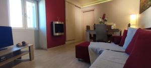a living room with a couch and a tv in it at Aegean View in Ermoupoli