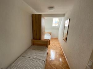 a small room with two beds and a hallway at Family apartment Tara in Mojkovac