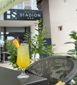 a glass of orange juice sitting on a table at Hotel Stadion in Oradea