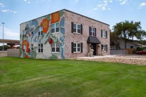 a building with a mural on the side of it at Dragon on Taylor St in Amarillo