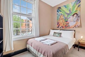 a bedroom with a bed and a window at Hidden retreat in the heart of the city - 2 Bed Apt in Nottingham