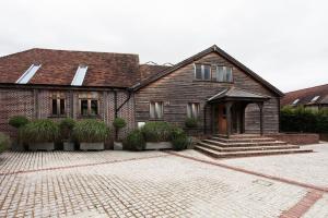 a house with a brick driveway in front of it at Whytings Stud Barn 2 in Horsham