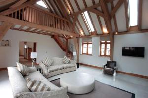 a living room with two couches and a table at Whytings Stud Barn 2 in Horsham