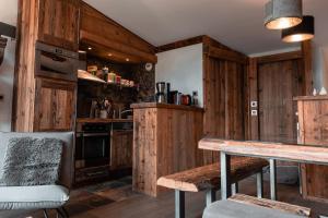 a kitchen with wooden walls and a wooden table at IMMODREAMS - Chalet Le Grand Paradis - Avoriaz in Avoriaz