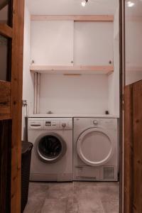 a laundry room with a washing machine and a washer at IMMODREAMS - Chalet Le Grand Paradis - Avoriaz in Avoriaz