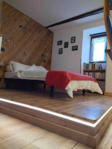 a bedroom with a bed with a wooden floor at Chez Jules in Saint-Martin-Vésubie